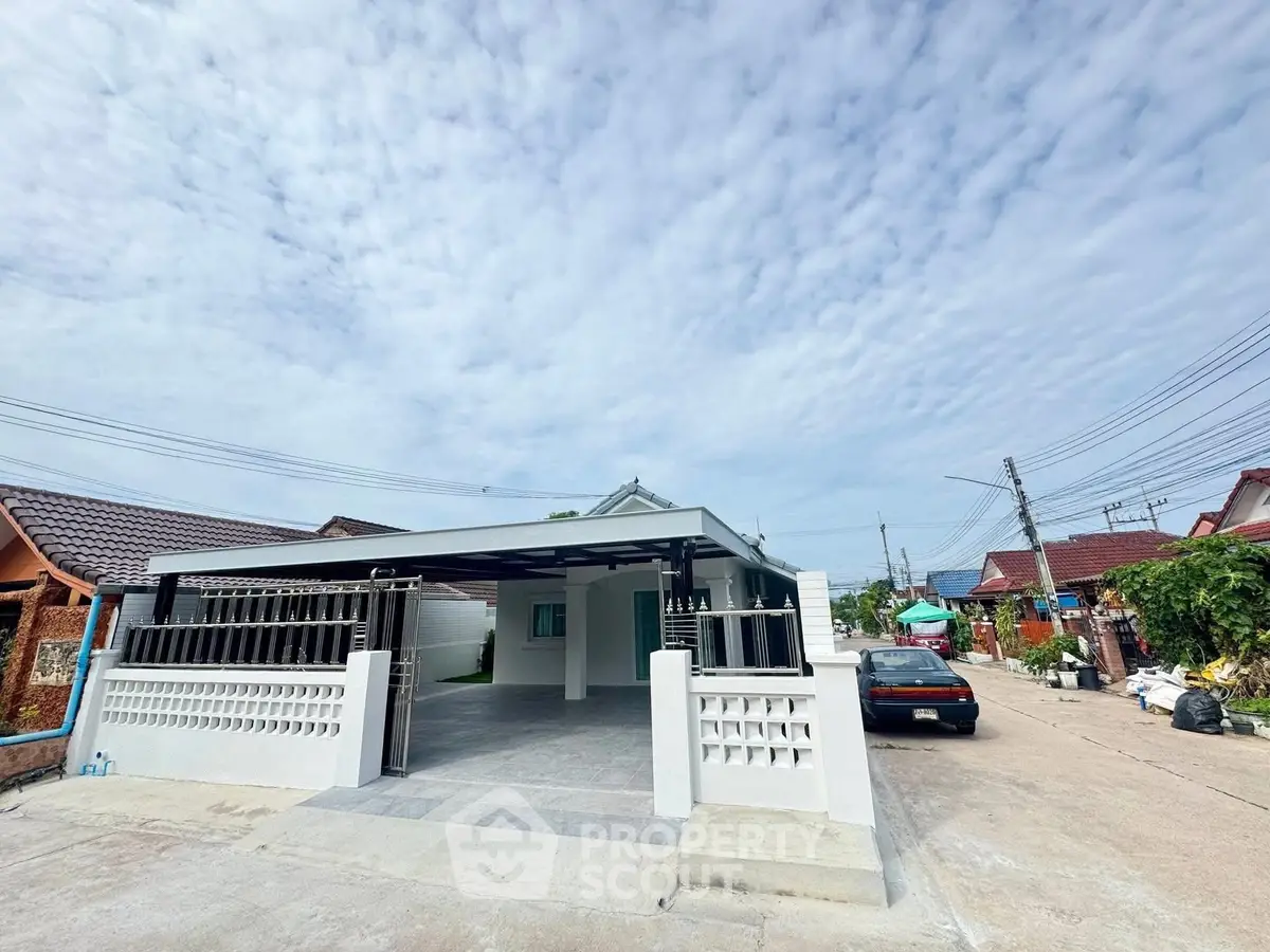 Charming single-story home with spacious driveway and modern exterior design.