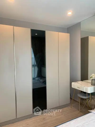 Modern bedroom with sleek wardrobe and stylish vanity set