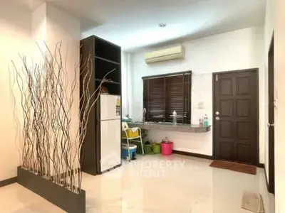 Modern kitchen with sleek design and open layout, featuring a refrigerator and stylish decor.
