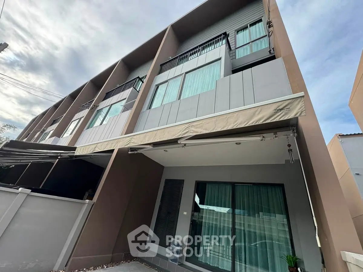 Modern townhouse exterior with sleek design and large windows in a desirable neighborhood.