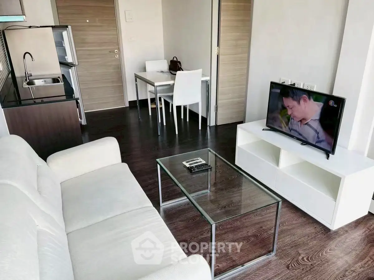 Modern living room with sleek furniture and open kitchen layout