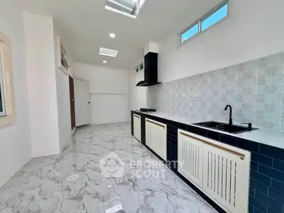 Modern kitchen with sleek design, featuring gas stove and stylish cabinetry.