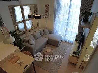 Modern living room with cozy sectional sofa and large windows offering natural light.
