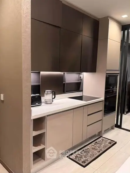 Modern kitchen with sleek cabinetry and built-in appliances in a stylish apartment.