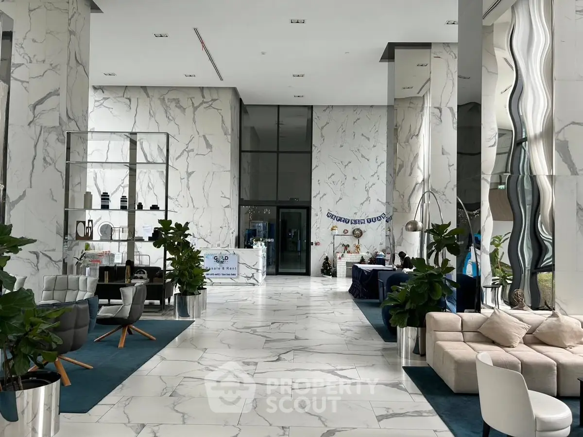 Luxurious modern lobby with marble flooring and elegant seating area.