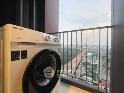 Modern balcony with washing machine and stunning city view, perfect for urban living.