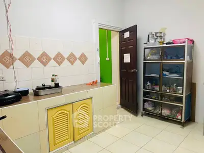Cozy kitchen with closed layout and ample storage space, featuring tiled backsplash and modern appliances.