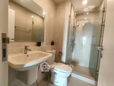 Modern bathroom with sleek fixtures and glass shower enclosure