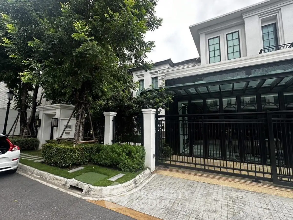 Luxurious modern house with elegant facade and lush greenery in a serene neighborhood.