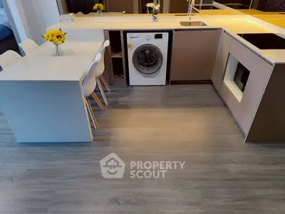 Modern kitchen with integrated washing machine and sleek countertops, perfect for urban living.