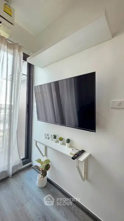 Modern living room with wall-mounted TV and sleek decor
