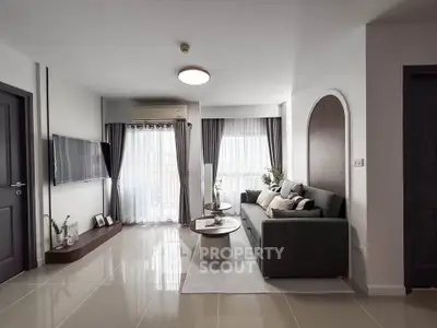 Modern living room with sleek design, large windows, and stylish furniture in a contemporary apartment.