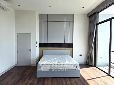 Spacious modern bedroom with large windows and elegant design