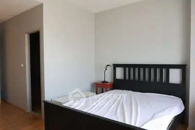 Spacious bedroom with modern bed frame and natural light