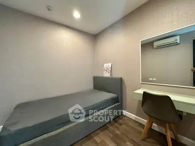 Modern bedroom with sleek design, featuring a comfortable bed and stylish desk, perfect for urban living.