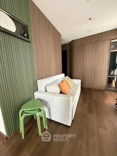 Modern living room with stylish wooden paneling and cozy sofa