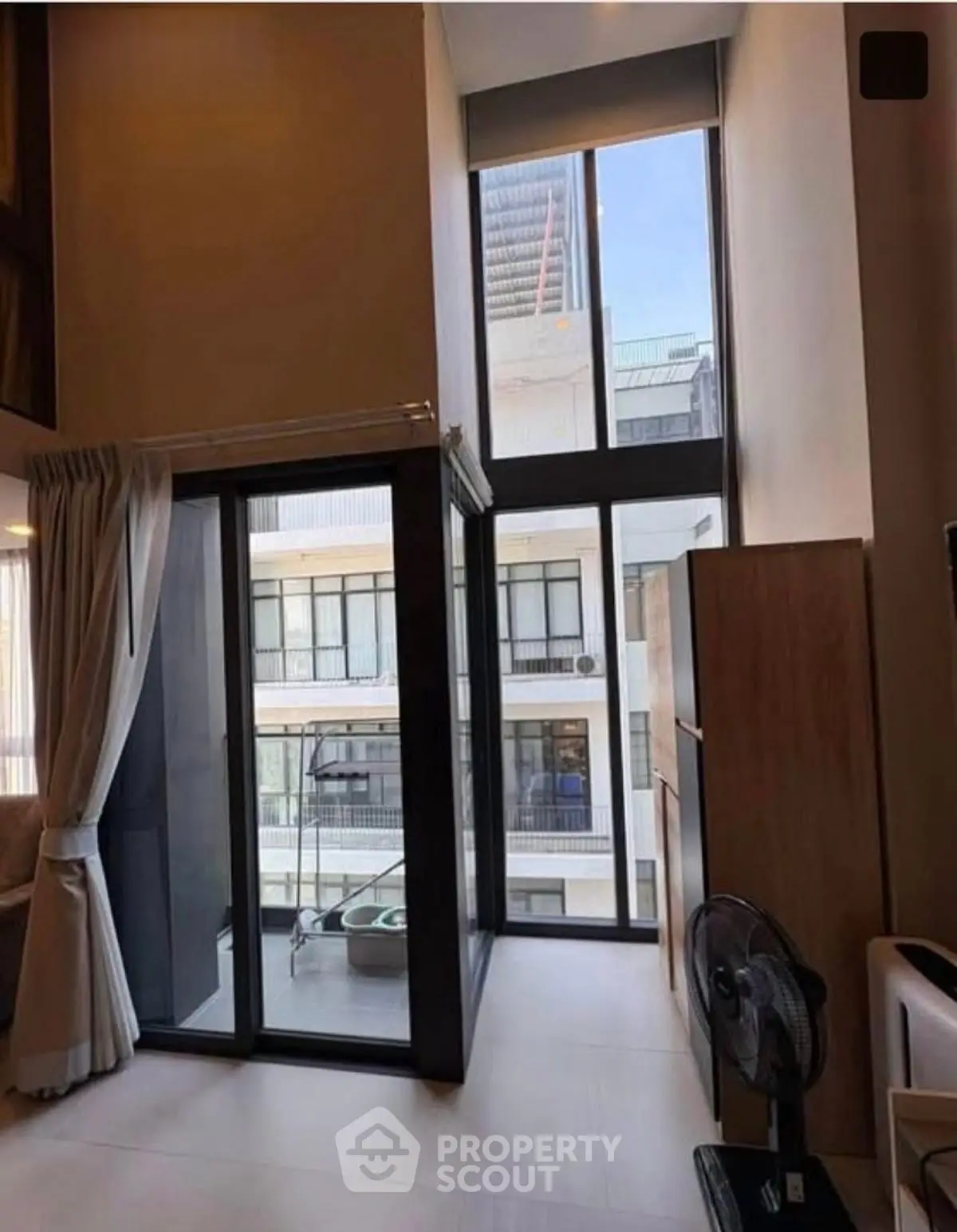 Modern apartment with floor-to-ceiling windows and balcony view