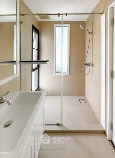 Modern bathroom with sleek shower and elegant fixtures in a contemporary home.