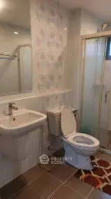 Modern bathroom with shower and stylish tiles, ideal for contemporary living.