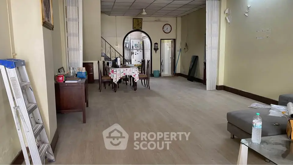 Spacious living room with dining area and modern decor in a cozy home.