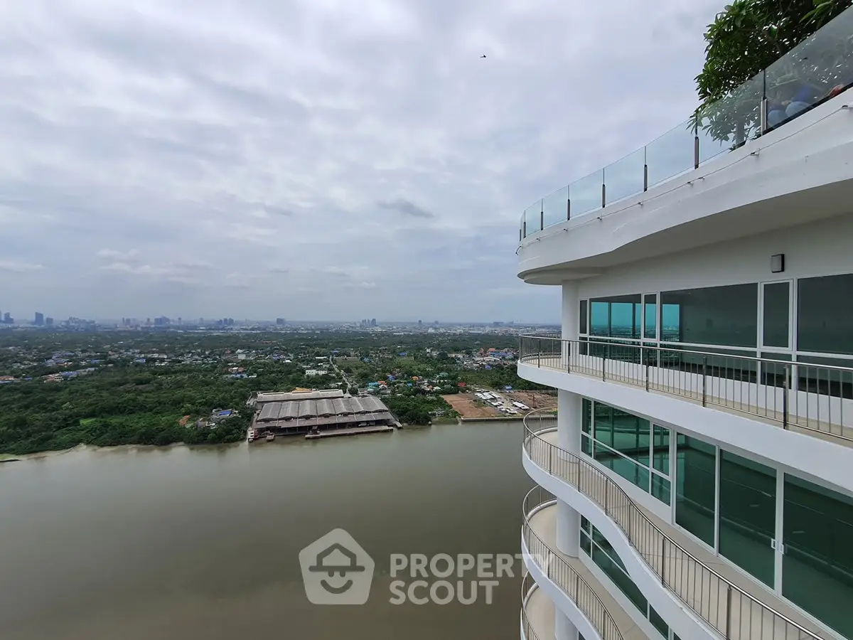 Stunning high-rise balcony view overlooking river and cityscape, perfect for urban living enthusiasts.