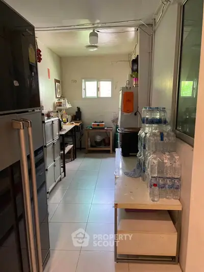 Compact kitchen with appliances and bottled water storage