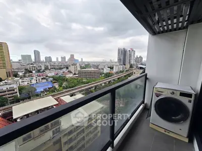 Stunning city view from high-rise balcony with washing machine
