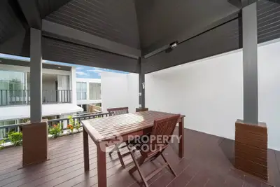 Modern outdoor balcony with stylish wooden furniture and sleek design, perfect for relaxation and entertainment.