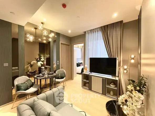 Modern living room with elegant decor and open dining area, featuring stylish lighting and cozy ambiance.