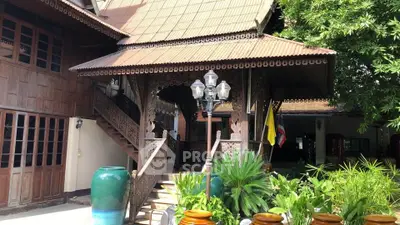 Charming traditional wooden house with intricate carvings and lush greenery