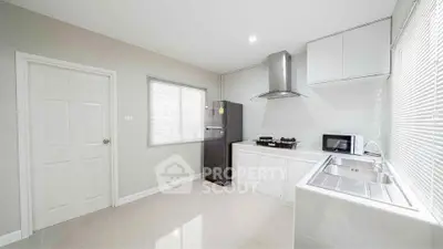 Modern kitchen with sleek appliances and ample natural light