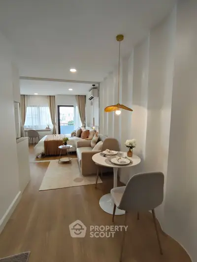 Modern studio apartment with open layout, cozy living area, and elegant dining space.