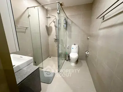 Modern bathroom with glass shower and sleek fixtures