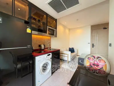 Modern studio apartment with sleek kitchen and cozy living area