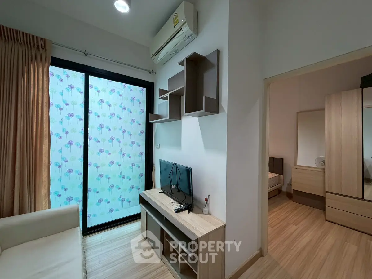 Modern living room with stylish furniture and sliding glass door