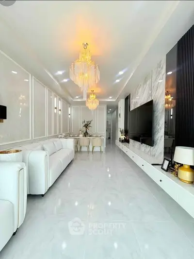 Luxurious modern living room with elegant chandeliers and marble accents