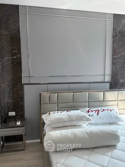 Luxurious bedroom with modern decor and plush bedding in a stylish apartment.
