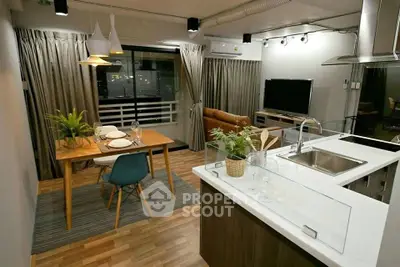 Modern open-layout living and dining area with stylish decor and kitchen island.