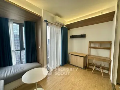 Modern living room with wooden flooring and stylish furniture in high-rise apartment.