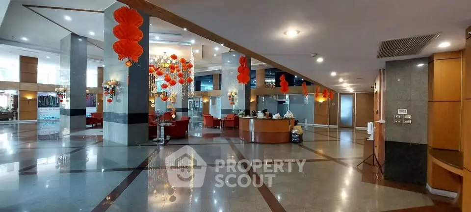 Spacious hotel lobby with elegant decor and festive red lanterns