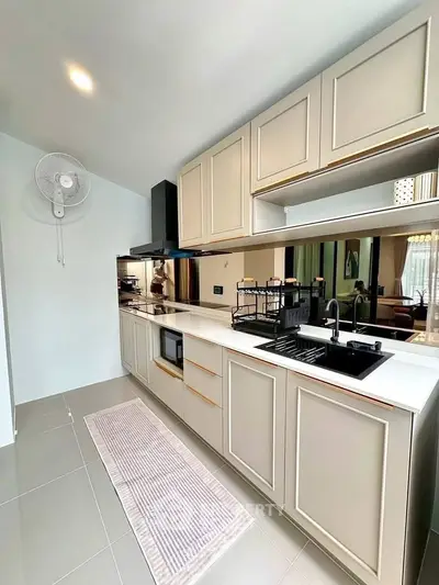 Modern kitchen with sleek cabinetry and built-in appliances in a stylish apartment.