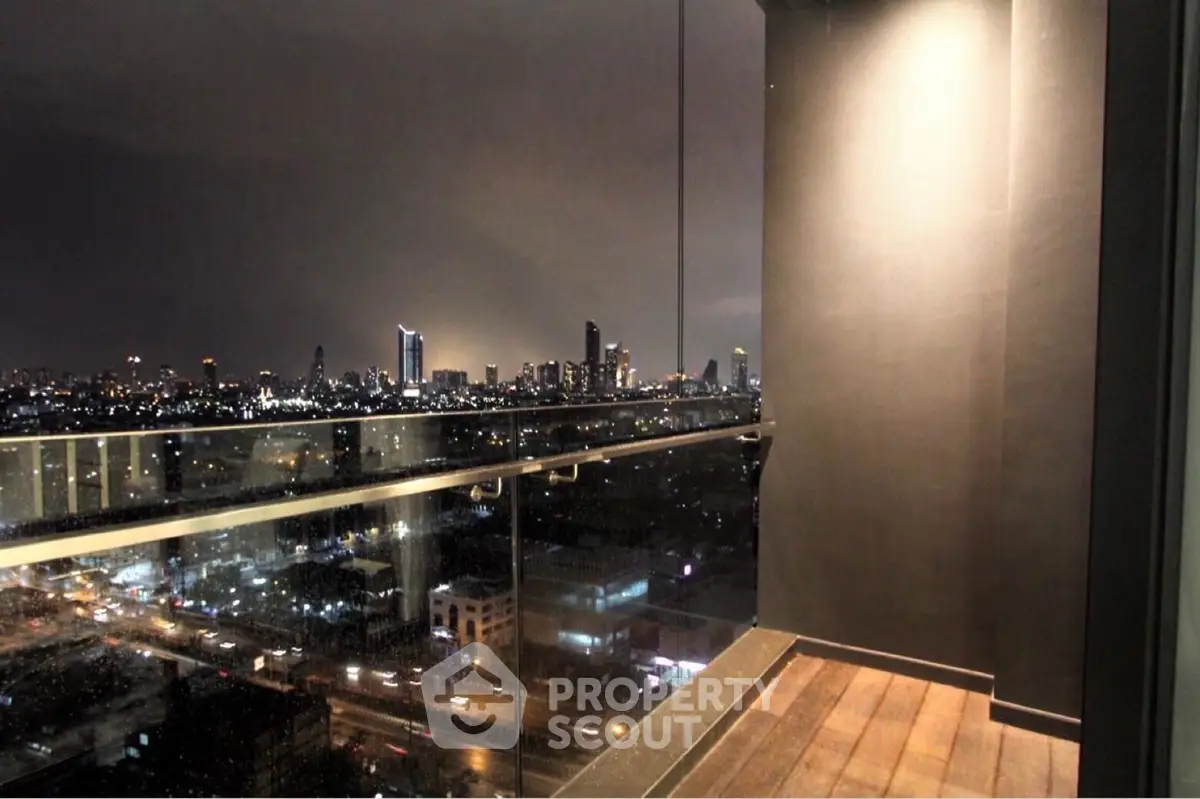 Stunning city skyline view from a modern glass balcony at night.