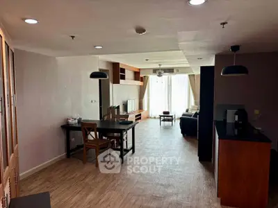 Spacious open-plan living room with modern furnishings and natural light.