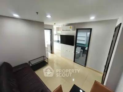 Modern living room with sleek design and open kitchen layout