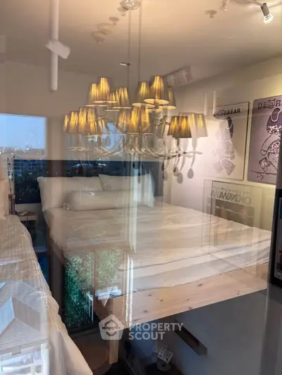 Modern bedroom with stylish chandelier and large window view, showcasing contemporary interior design.