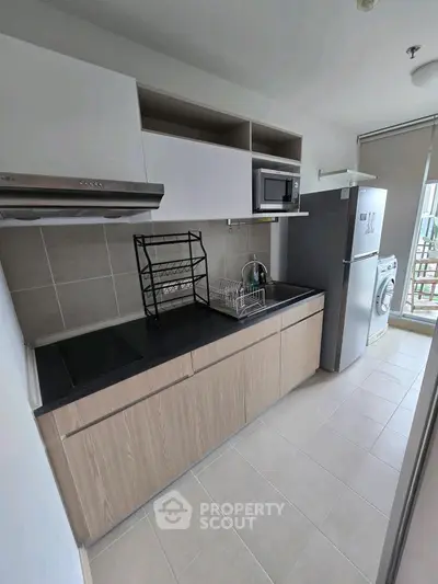 Modern kitchen with sleek appliances and open layout in a stylish apartment.