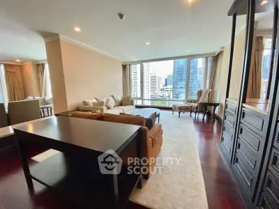 Spacious living room with city view, elegant furnishings, and large windows in a modern apartment.