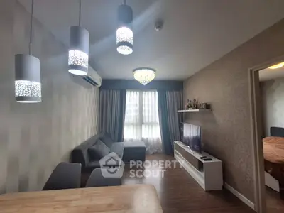 Modern living room with stylish lighting and cozy furniture, perfect for relaxation and entertainment.