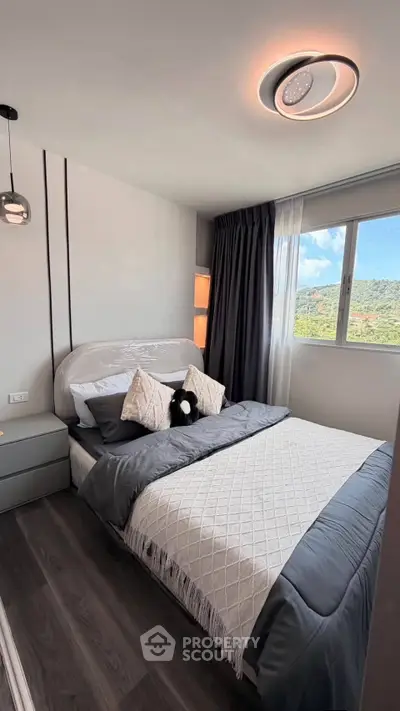 Modern bedroom with stylish decor and scenic window view