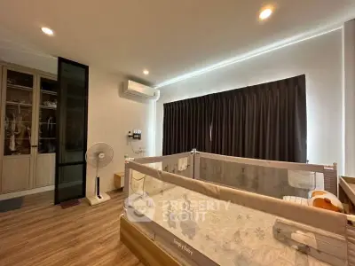 Cozy bedroom with crib, air conditioning, and ample closet space, perfect for a growing family.